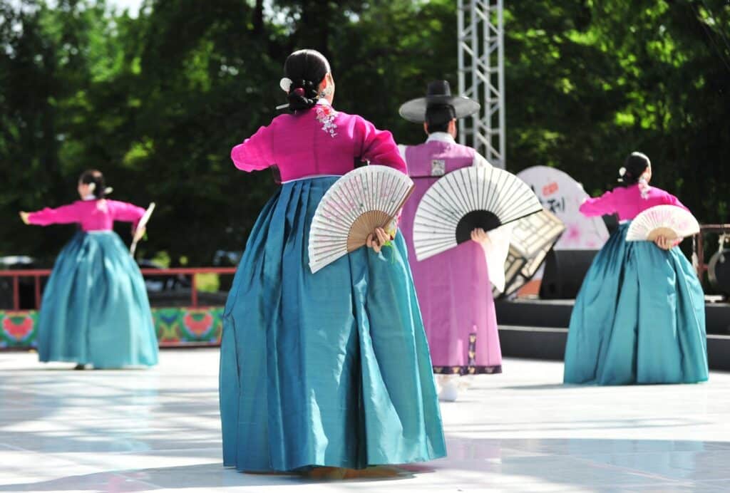 Integrantes da V Mostra Cultural Coreana apresentam dança tradicional com hanbok e leques